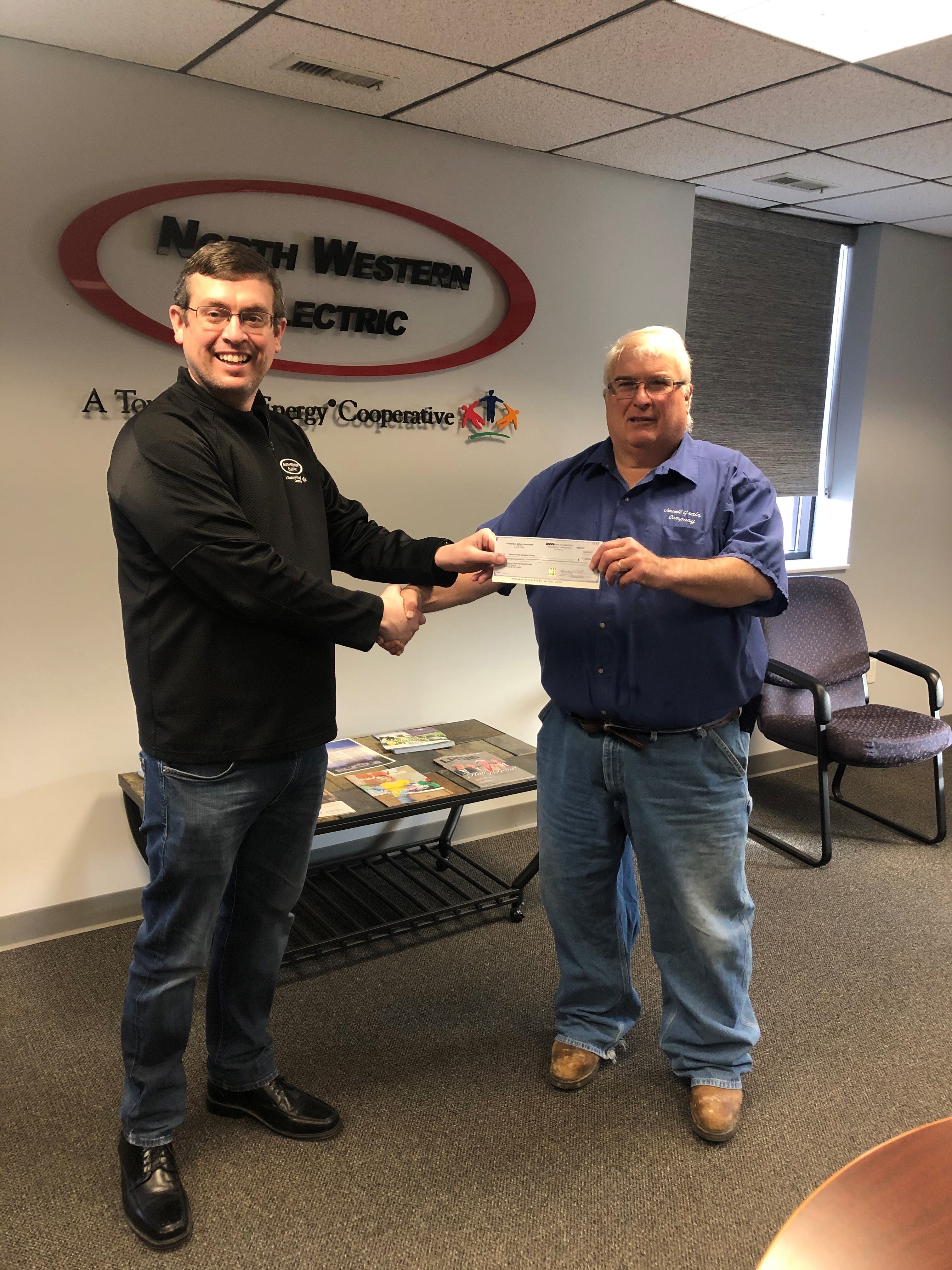 NWEC employee hands over check