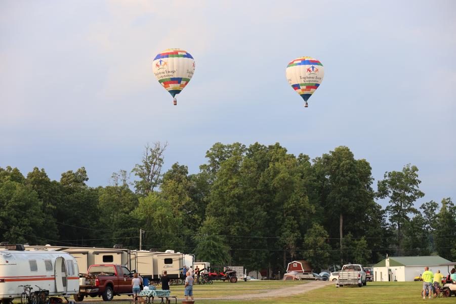 two balloons floating over campground