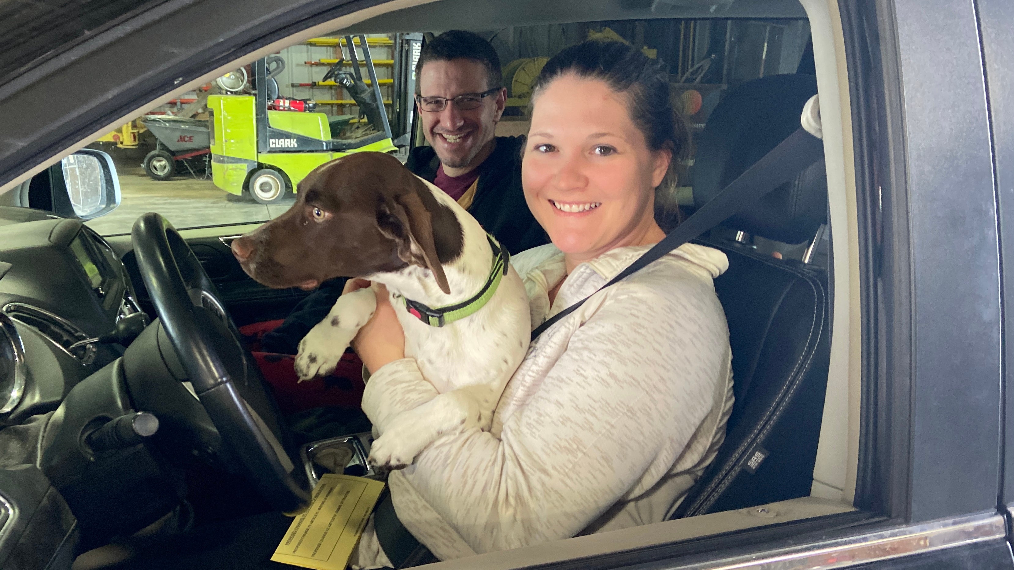 couple with dog in van