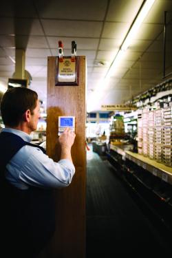 Business Man Adjusting Thermostat